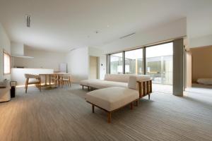ein Wohnzimmer mit Sofa und Tisch in der Unterkunft JINRYU Hotel ISE in Ise
