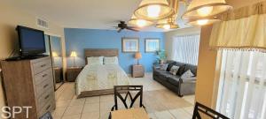 a bedroom with a bed and a flat screen tv at Great Pool - Beach Access - Small Family Perfect in South Padre Island +53 photos