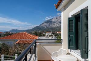 a balcony with chairs and a view of a mountain at So Nice Hotel in Marathokampos