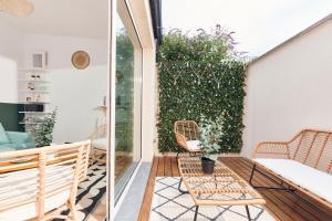 a small balcony with chairs and a plant at Charmant T2 - 2min de Lille in Ronchin