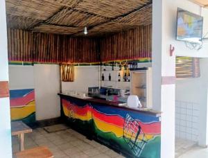 a kitchen with a colorful counter in a room at Madibak Hotel Limbe in Limbe