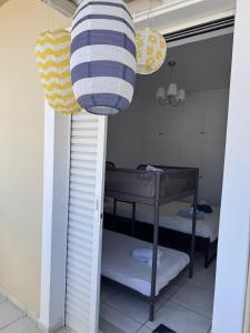 a room with two bunk beds and two lights at J&J spacious balcony apartment in Preveza