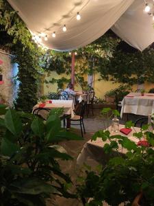 a man sitting at a table in an outdoor restaurant at Locanda Tarello 1880 in Roppolo