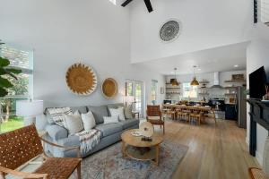 a living room with a couch and a table at Rosé Retreat: Luxurious Getaway for 6, Hot Tub, Steps to Main Street in Fredericksburg
