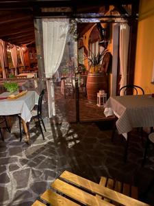 a restaurant with tables and chairs in a room at Locanda Tarello 1880 in Roppolo