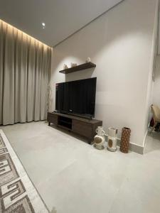 a living room with a flat screen tv on a wall at شقة مفروشة in Al Khobar