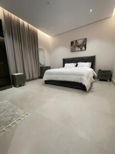 a bedroom with a large bed and a large window at شقة مفروشة in Al Khobar