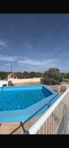 a large blue swimming pool on top of a building at Casa Latina in Moralet