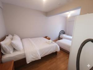 a small bedroom with two beds and a mirror at Karakum Panorama Suites in Sinop