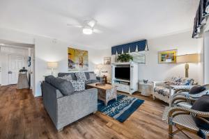 a living room with a couch and a tv at Dog Friendly Ground Level Duplex in Fernandina Beach
