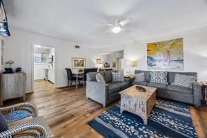 a living room with a couch and a table at Dog Friendly Ground Level Duplex in Fernandina Beach
