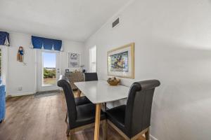 a dining room with a white table and chairs at Dog Friendly Ground Level Duplex in Fernandina Beach +34 photos