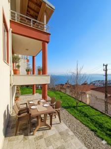 a patio with a table and chairs on a balcony at Karakum Panorama Suites in Sinop