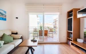 a living room with a couch and a table at BONITO APARTAMENTO in Sitges