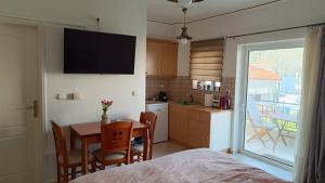 a kitchen and dining room with a table and chairs at Lena's Nest Nafpaktos in Nafpaktos