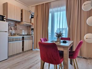 a kitchen and dining room with a table and chairs at SeaLaVie - Summerland Mamaia in Mamaia