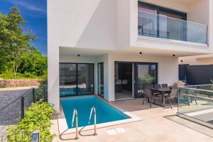 an image of a house with a swimming pool at Brand new apartment with private pool in Njivice