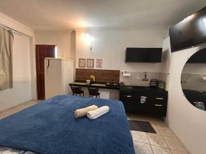 a bedroom with a blue bed with two towels on it at Condomínio Boa Ideia apart completo ao lado North Shopping Maracanaú in Maracanaú