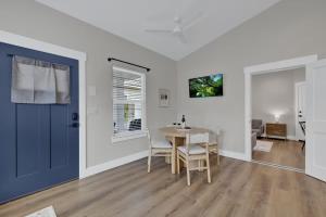 a dining room with a table and a blue door at The Grove Combo in Fredericksburg