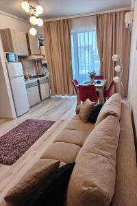 a large couch in a living room with a table at SeaLaVie - Summerland Mamaia in Mamaia +17 photos
