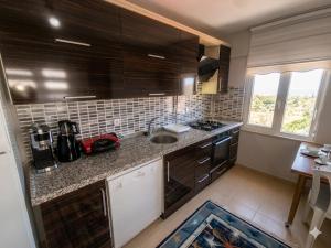 a kitchen with a sink and a counter top at Karakum Panorama Suites in Sinop