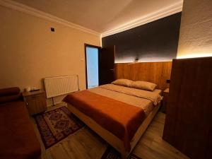 a bedroom with a bed and a large window at Hotel Lido in Prishtinë +6 photos