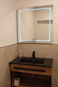 a bathroom with a sink and a mirror at Hotels-in-Alsdorf in Alsdorf