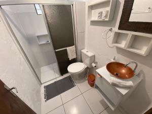 a small bathroom with a sink and a toilet at Casa de Férias Balneário Gaivota in Balneário Gaivotas +14 photos
