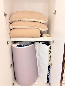 a closet filled with pillows and blankets at pp villa phatthalung in Phatthalung