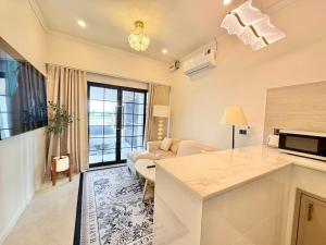 a kitchen and living room with a couch and a table at pp villa phatthalung in Phatthalung