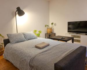 a bedroom with a bed and a flat screen tv at Patio by the sea in Cruz Quebrada