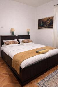 a large bed in a bedroom with two pillows at Tri srca 2 - De Luxe 2 in Trebinje