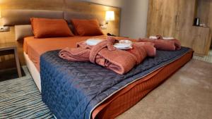 a hotel room with a bed with towels on it at Naftalan Central Wellness Resort in Naftalan