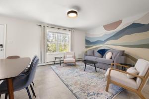 a living room with a couch and a table at Maine Woods Retreat in Ellsworth
