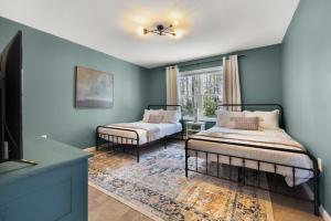 a room with two beds and a window at Maine Woods Retreat in Ellsworth