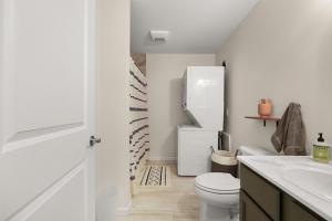 a white bathroom with a toilet and a refrigerator at Maine Woods Retreat in Ellsworth +19 photos