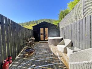 a wooden deck with a black tiny house at Foxglove cabin in Bodmin +3 photos