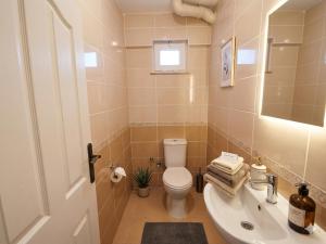 a bathroom with a toilet and a sink at Karakum Panorama Suites in Sinop +13 photos