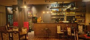 a restaurant with a bar with chairs and a counter at Hotel Lido in Prishtinë