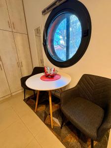 a table and a chair in a room with a window at Central & Riverfront Room 1 in Edessa