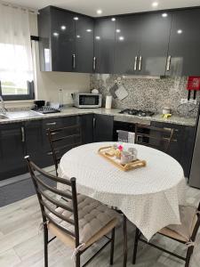 a kitchen with a table and two chairs and a sink at Terraço d’Aldeia in São Pedro do Sul