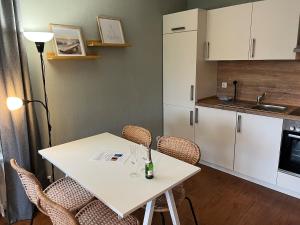a small kitchen with a white table and chairs at Auszeit im alten Land 2 in Buxtehude