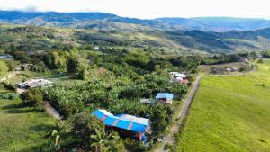an aerial view of a house on a hill at Casa La Aurora Posada in Restrepo +21 photos