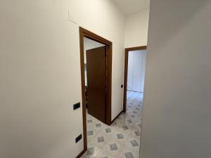 an empty room with a door and a hallway at Apartment house in the center in Oggiono