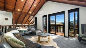 a living room with a couch and a table at Mountain View Chalet in Wanaka +20 photos