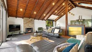 a living room with a couch and a fireplace at Mountain View Chalet in Wanaka