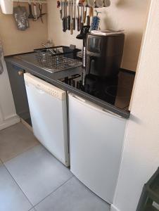 a kitchen with a stove top oven next to a dishwasher at Villa jendy in Soustons