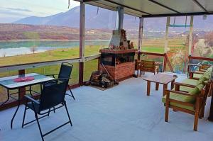a patio with a fireplace and a table and chairs at Camping SuperPanorama in Kukës