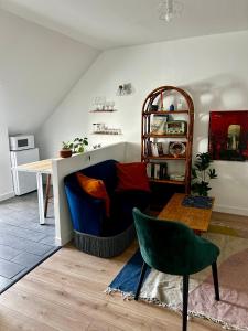 a living room with a couch and a table at Appartements Lambotte in LʼAigle