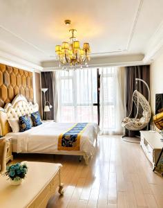 a bedroom with a large bed and a chandelier at Pu Yu Apartment in Shanghai +120 photos